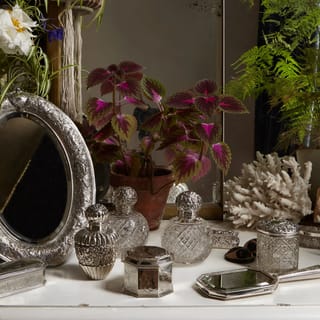 A dressing table decorated with sterling silver dressing table items